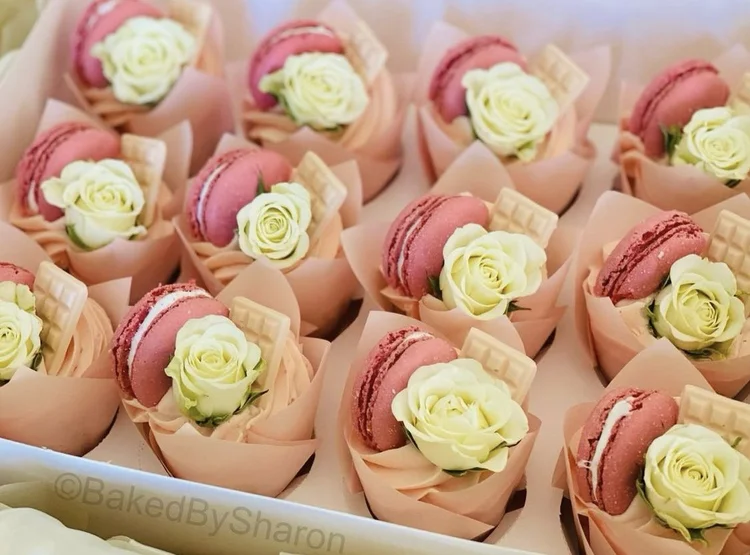 Pink macarons topped with sugar roses